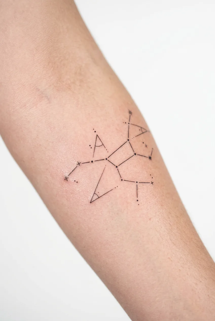 Constellation map tattoo on forearm showing connected stars with fine lines and celestial patterns