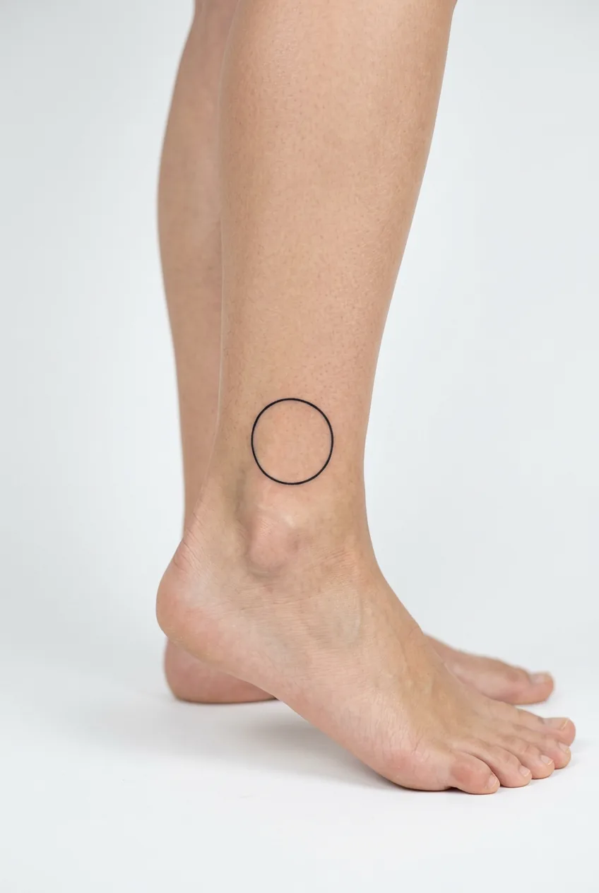 Perfect geometric circle tattoo located precisely on woman's ankle bone