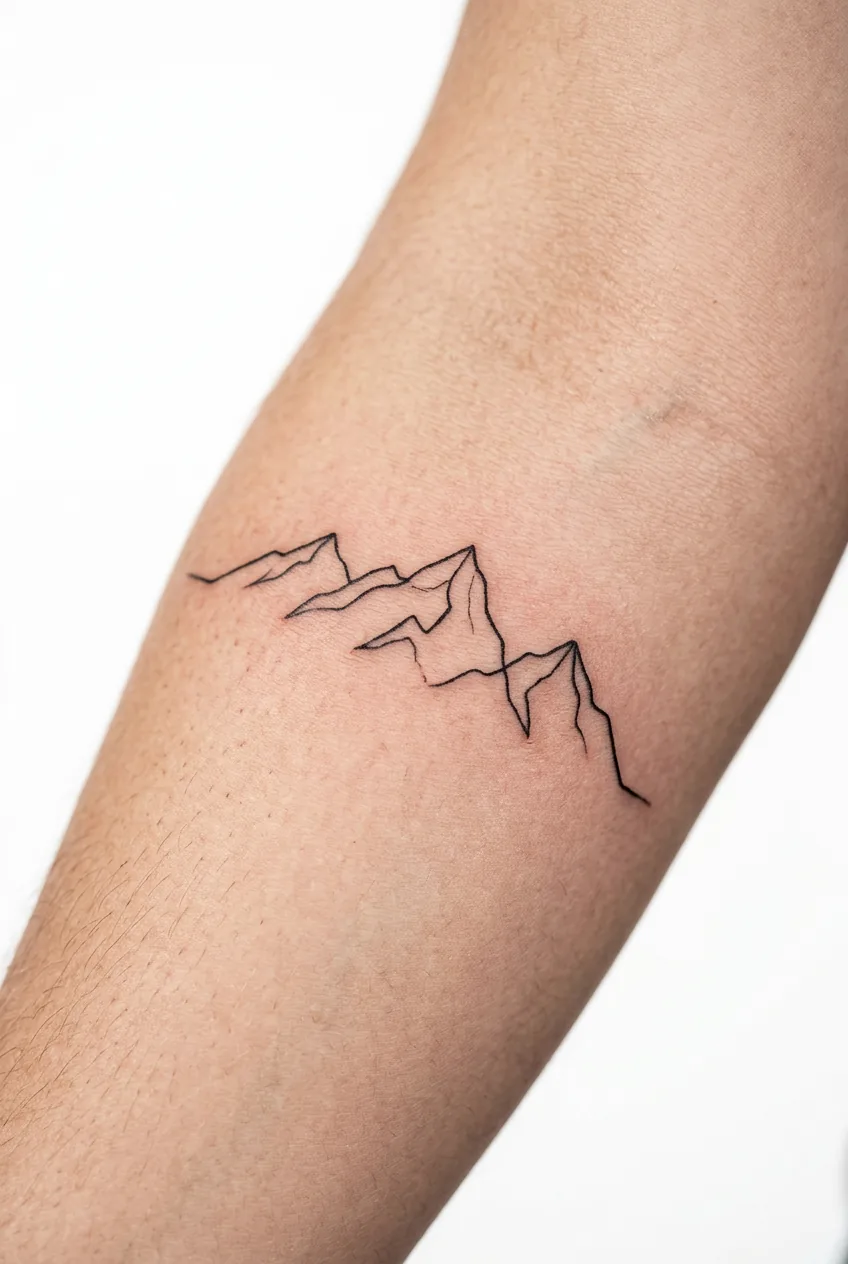 Fresh single continuous line mountain range tattoo wrapping around woman's forearm